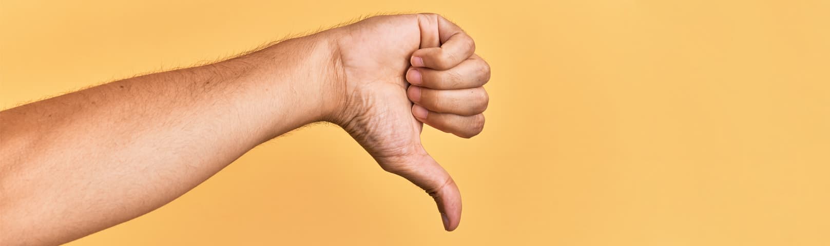 Man's hand pointing down in disapproval
